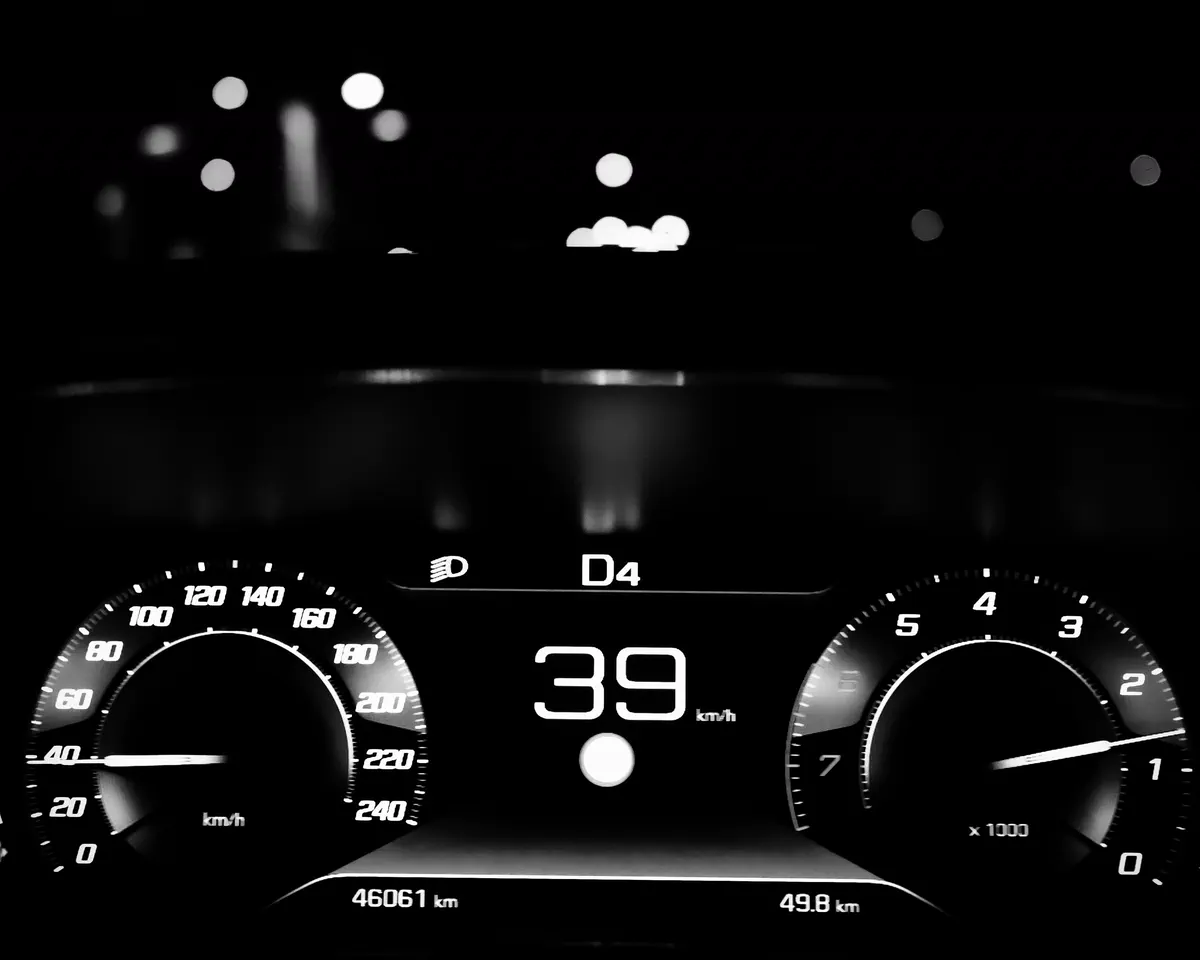 Monochrome car dashboard illuminated at night
